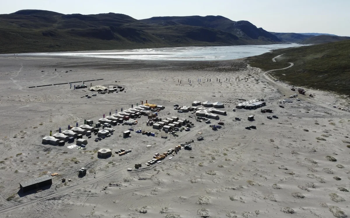 The Extreme E race site from the air, tents and containers on the sand plain at Kangerlussuaq