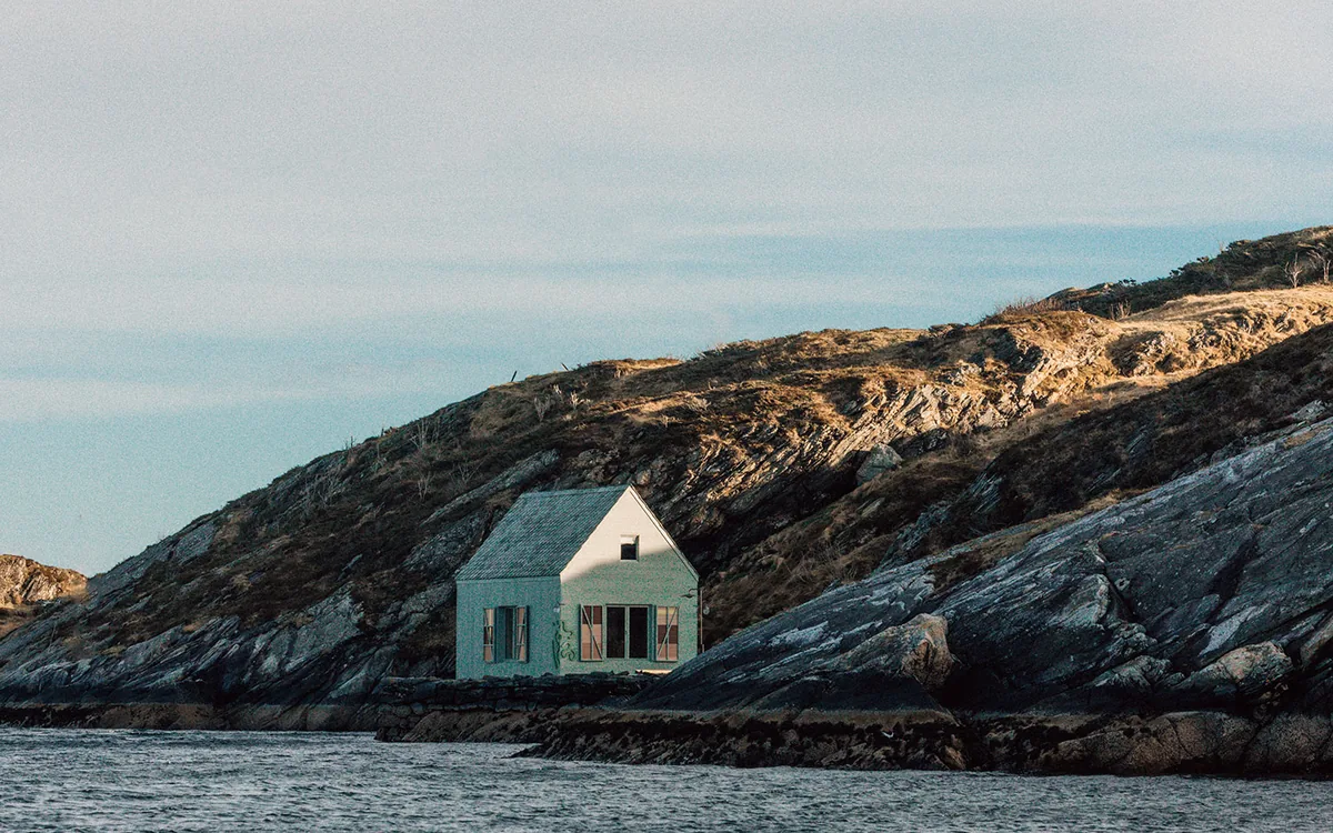 White house on coastal rocks by the sea