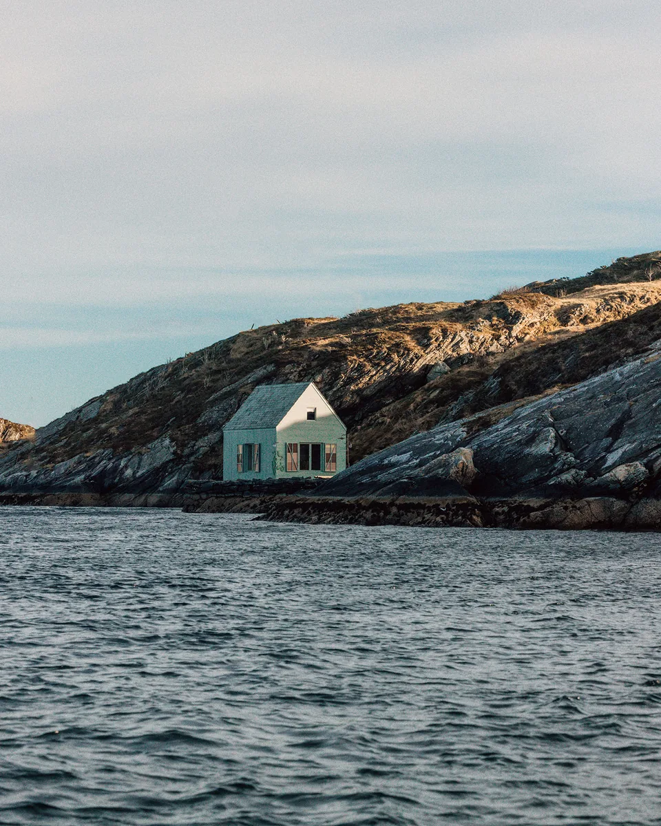 White house on coastal rocks by the sea