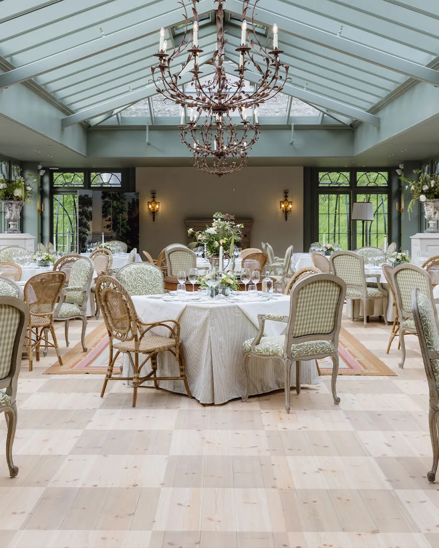 Conservatory dining room laid for dinner